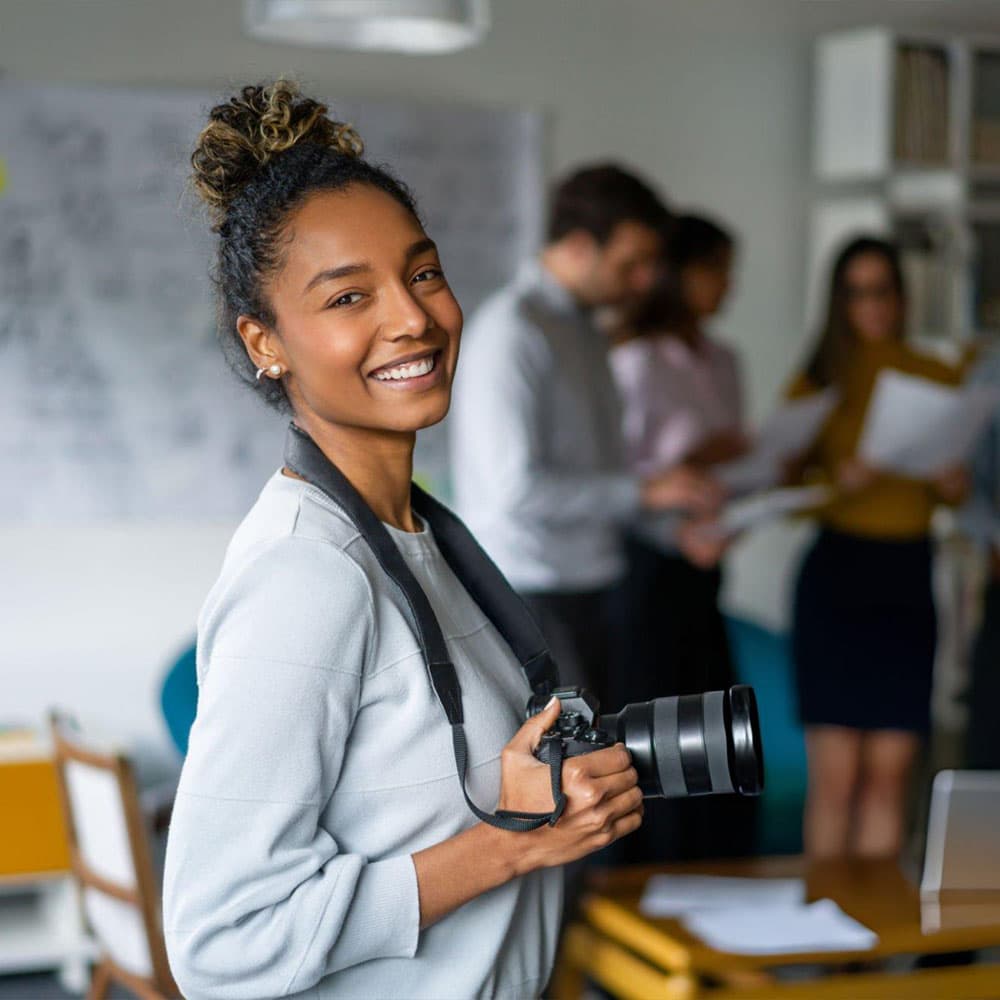 A Teltita visual producer on set with a camera